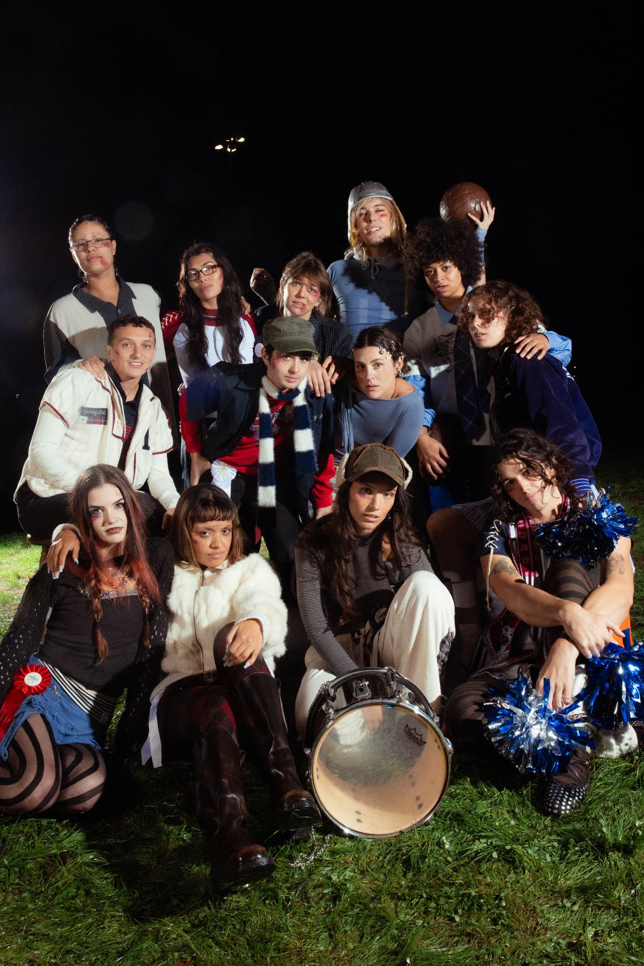 Janky Inc. Limited — a twelve-person group portrait in layered janky fashion around a snare drum on a night field