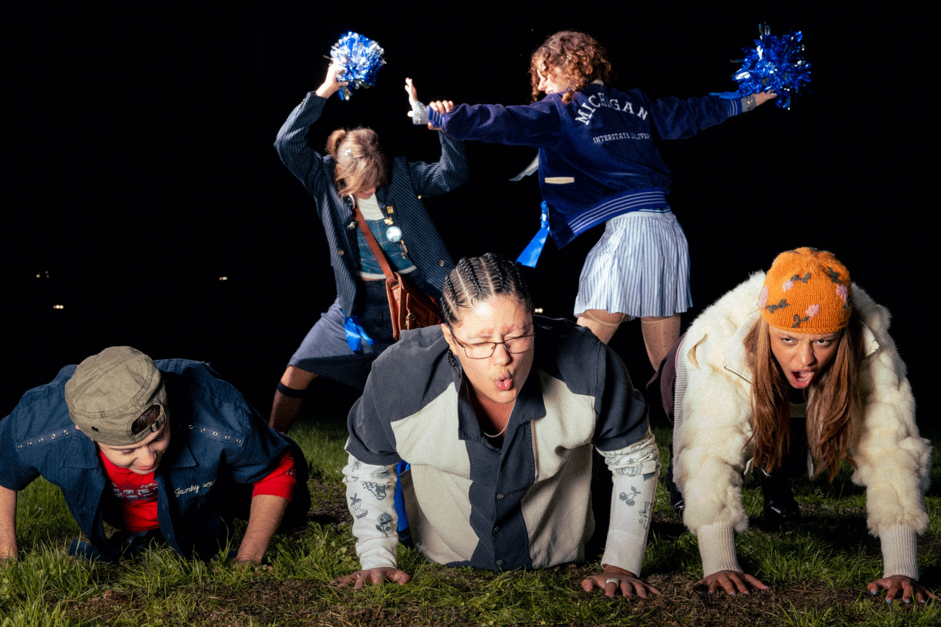Janky Inc. Limited — three friends on all fours in a scrimmage line with two cheerleaders behind them on a night field