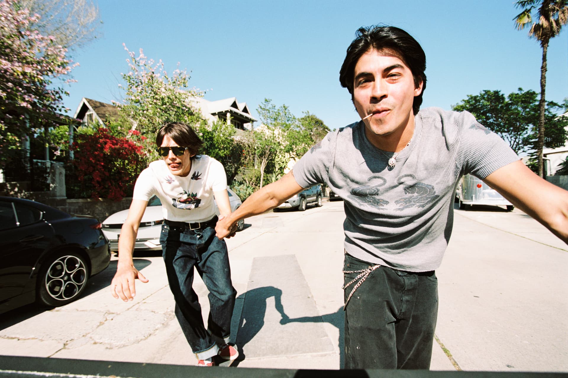 Janky Inc. SS25 — two young men holding hands down a sunny street