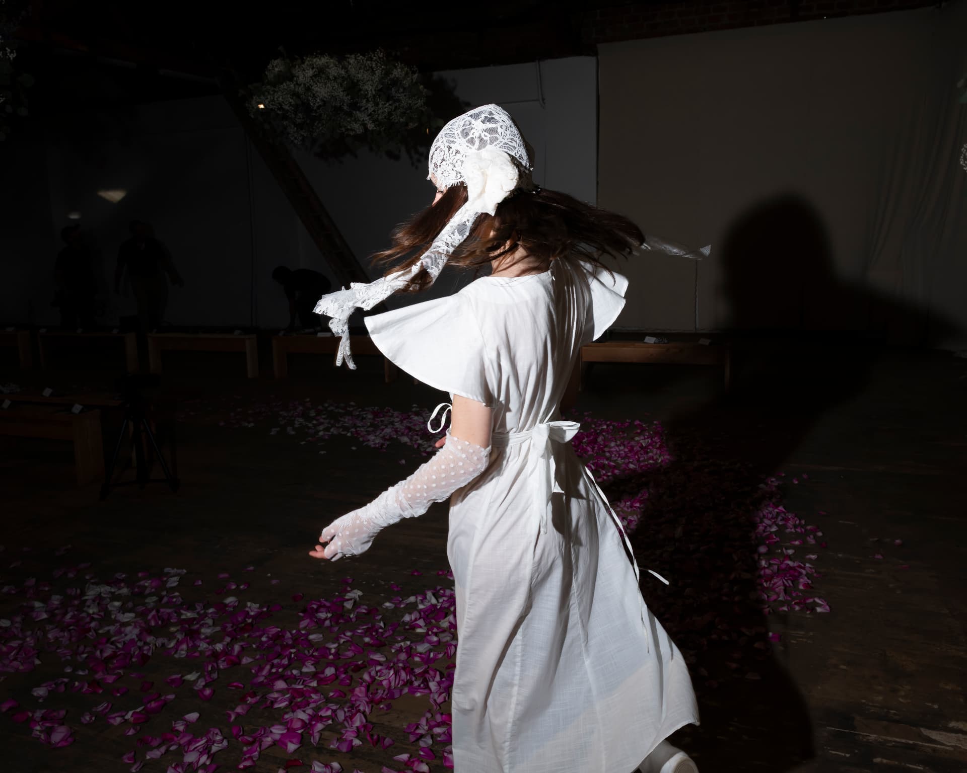 Ella Mae SS26 — white dress turning across rose petals