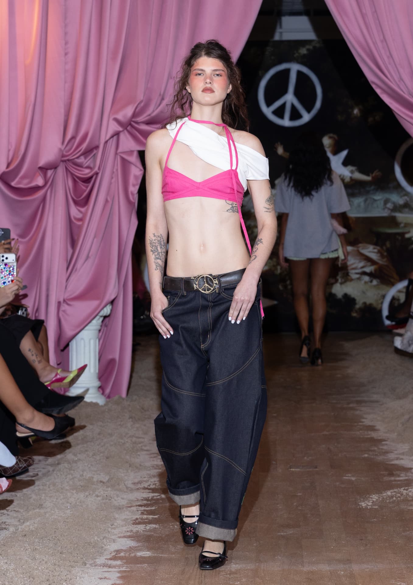Ella Mae SS27 — baggy dark denim with a hot pink bikini top and bunched white shirt