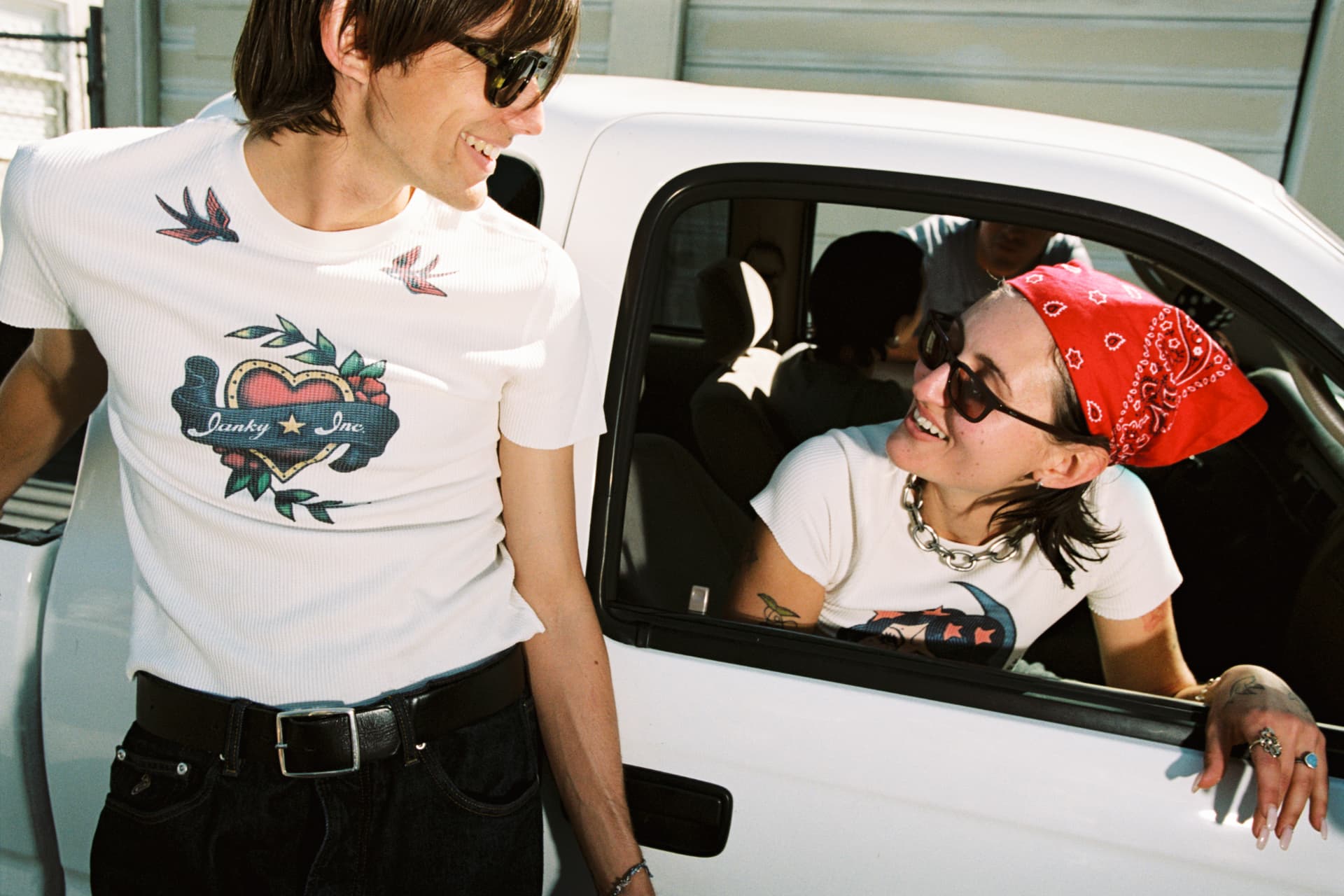 Janky Inc. SS25 — man and woman in Janky Inc. tees by a white truck